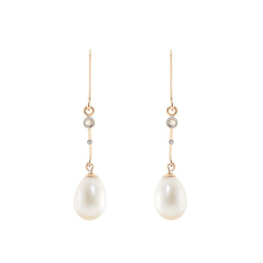 Delicate vintage 18ct gold dangling earrings, each set with a mine cut diamond and a lustrous pearl drop.