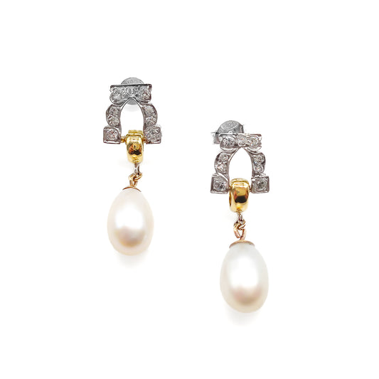 Stunning pair of 18ct white and yellow gold dangling earrings, each set with six small diamonds and a pearl drop.