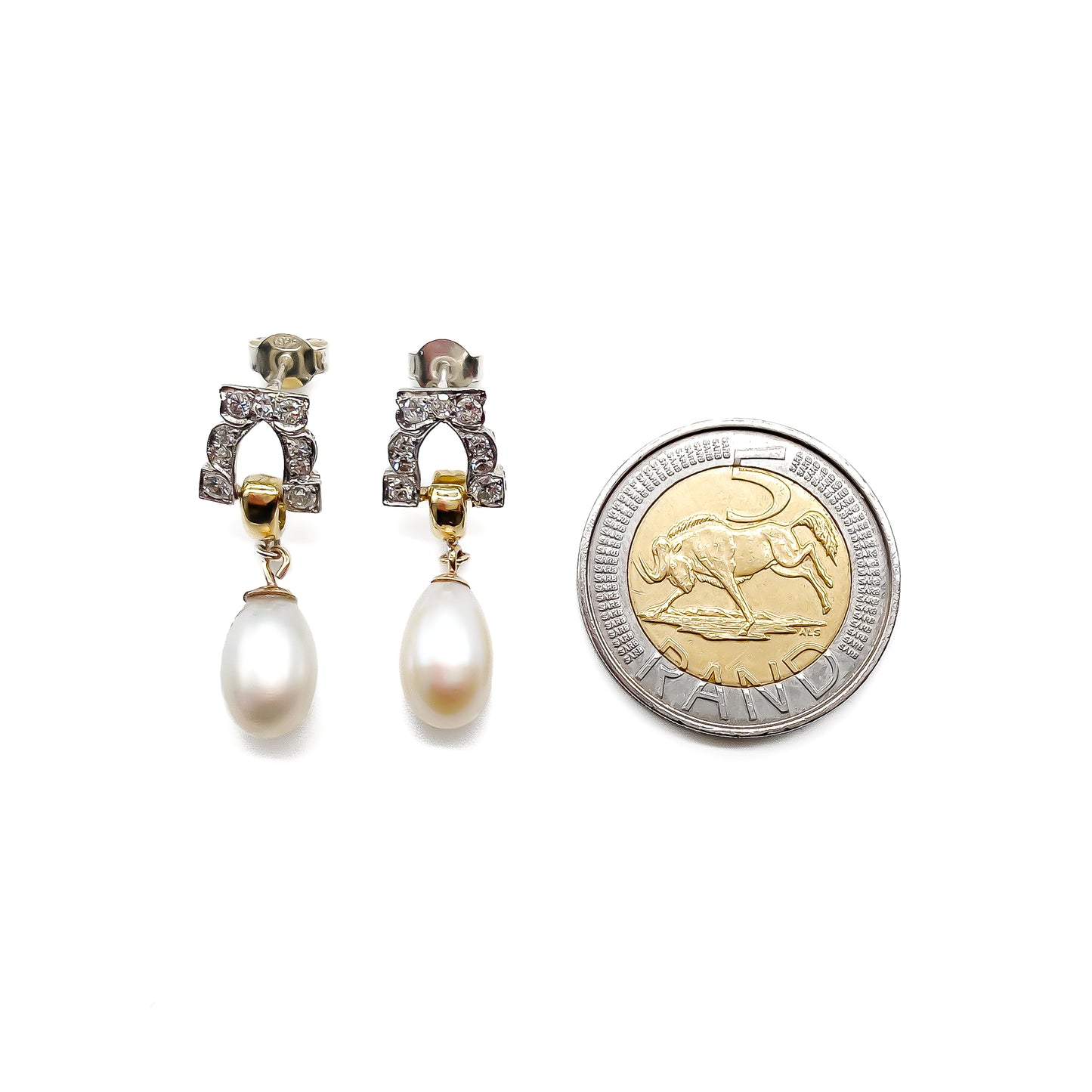 Stunning pair of 18ct white and yellow gold dangling earrings, each set with six small diamonds and a pearl drop.