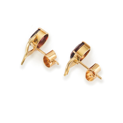 Classic 18ct gold stud earrings, each set with a deep red, beautifully faceted garnet gemstone.