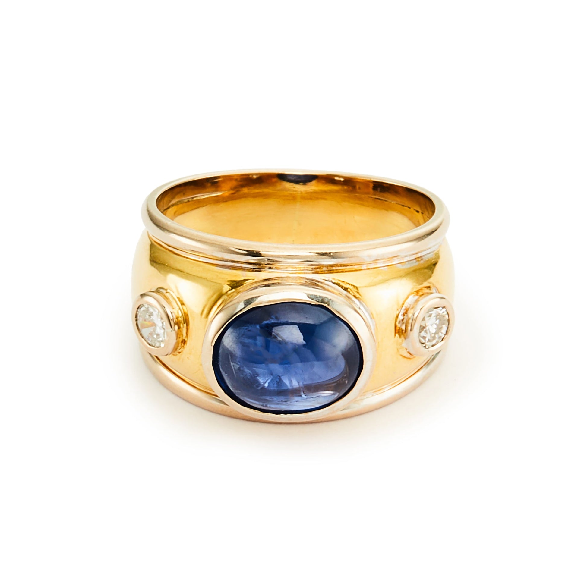 Glamorous 18ct yellow and white gold ring tube-set with a centre cabochon sapphire and a diamond on each side.