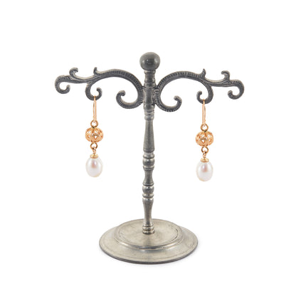 Vintage 18ct yellow gold dangling earrings, each set with a lustrous pearl drop.