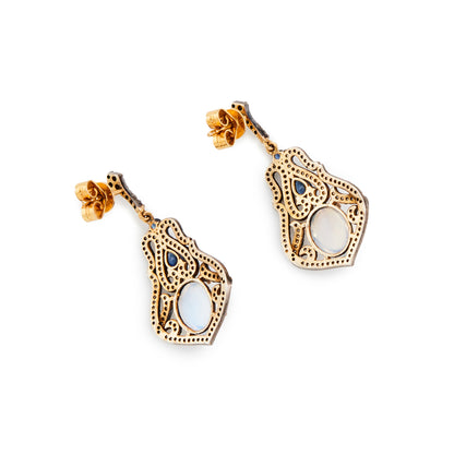 Exquisite drop earrings each with a cabochon moonstone, two faceted sapphires, surrounded by multiple tiny diamonds in a silver on 18ct gold setting and 18ct gold butterflies. Italy