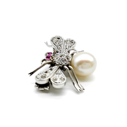 Dainty 18ct white gold insect brooch with diamonds on the wings and thorax, ruby eyes and a pearl abdomen. 