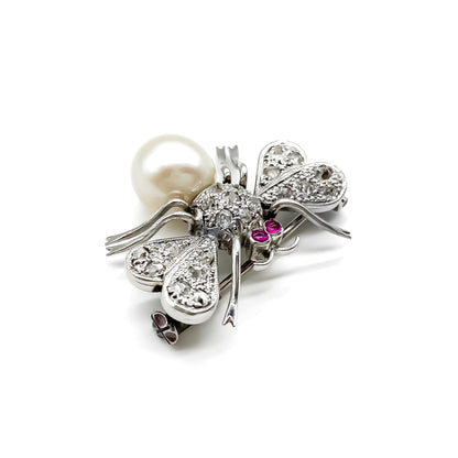 Dainty 18ct white gold insect brooch with diamonds on the wings and thorax, ruby eyes and a pearl abdomen. 