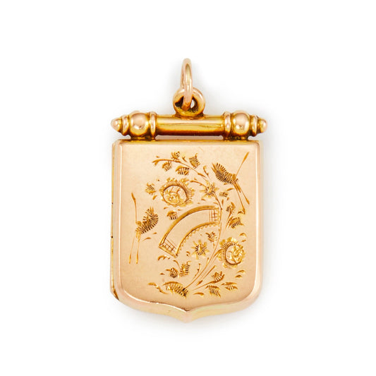 Exquisite Victorian 9ct rose gold back and front locket in the shape of a shield with intricate engraving depicting birds and flowers. The locket has space for two photographs.
