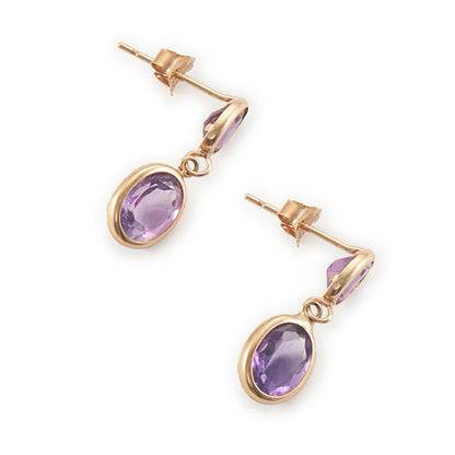 Dainty vintage 9ct gold drop earrings, each with two tube-set faceted purple amethyst stones.