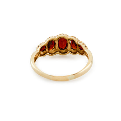 Lovely 9ct gold ring set with five beautifully faceted deep red oval garnets.