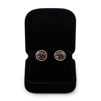 Stylish 9ct gold stud earrings, each set with a lovely, deep-red, round cabochon garnet.