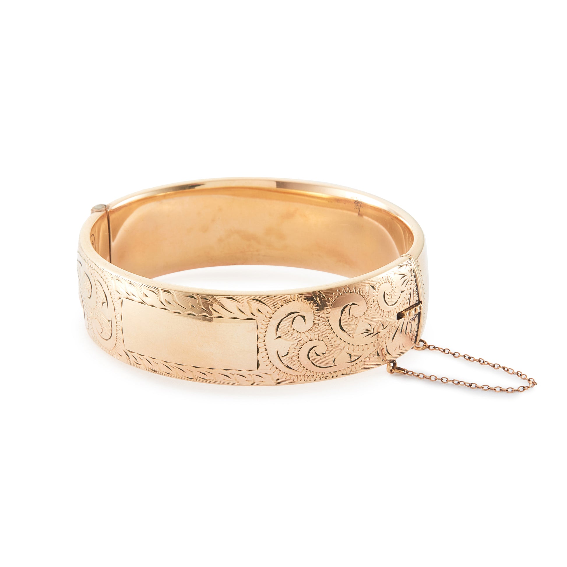 Vintage, beautifully engraved ⅕ 9ct rose gold metal core hinged bangle with a safety chain.