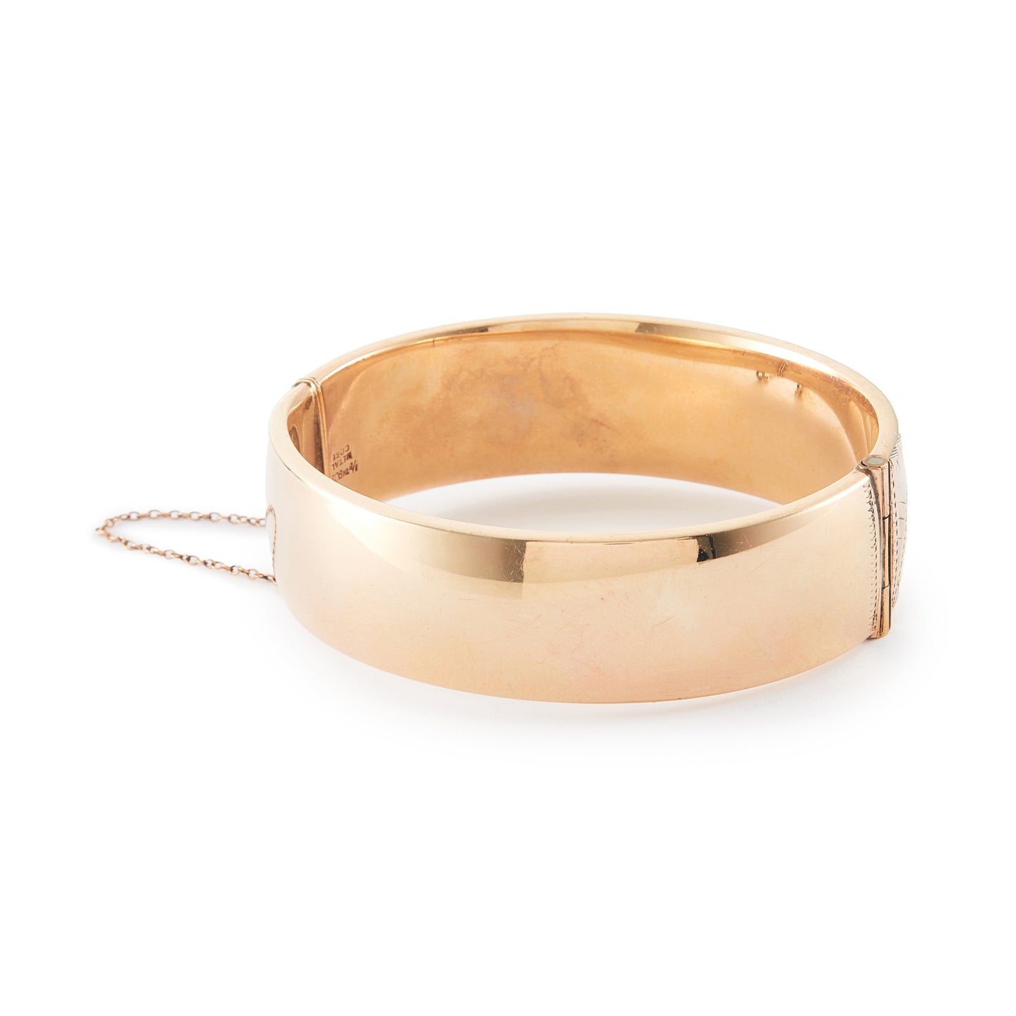 Vintage, beautifully engraved ⅕ 9ct rose gold metal core hinged bangle with a safety chain.