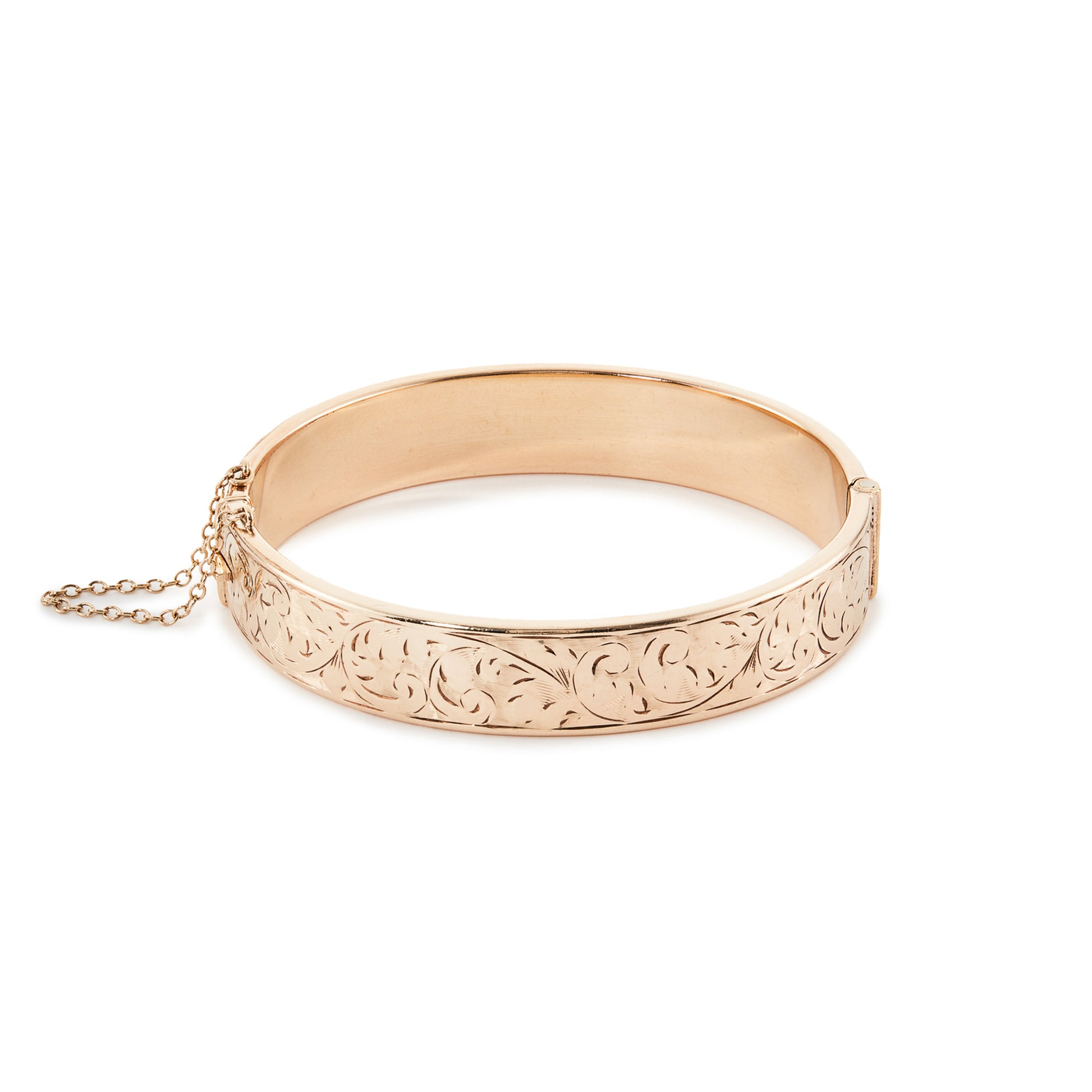 Beautifully engraved vintage 9ct gold metal core bangle. Stamped ⅕th 9ct metal core. Safety chain attached.