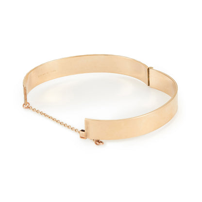 Beautifully engraved 9ct gold metal core bangle. Hinge clasp with safety chain attached.