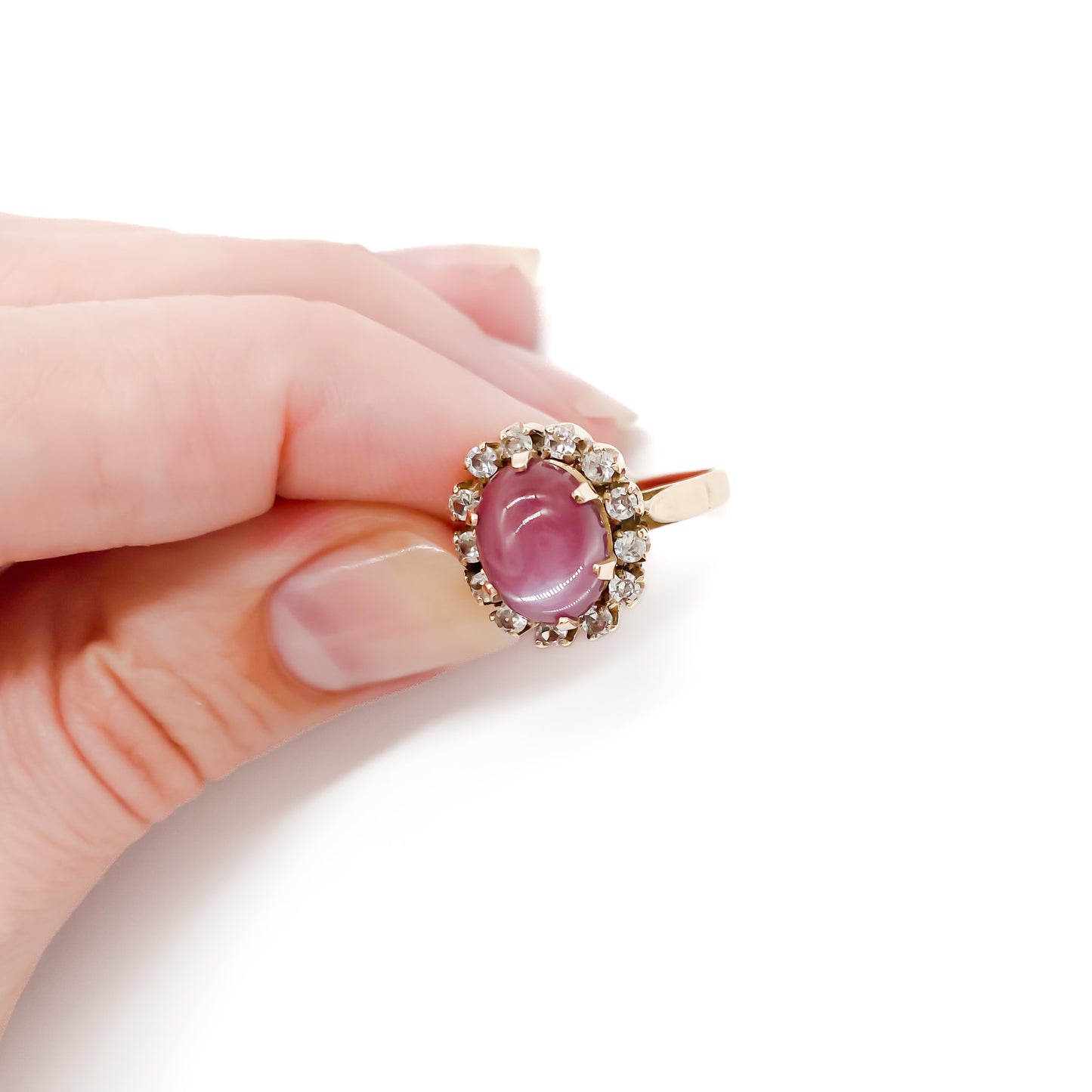 Lovely 9ct gold vintage ring set with an oval dusty pink quartz cabochon, surrounded by thirteen white faceted spinel stones.