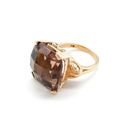 Classic 9ct yellow gold ring set with a beautifully faceted cushion-cut smoky quartz.