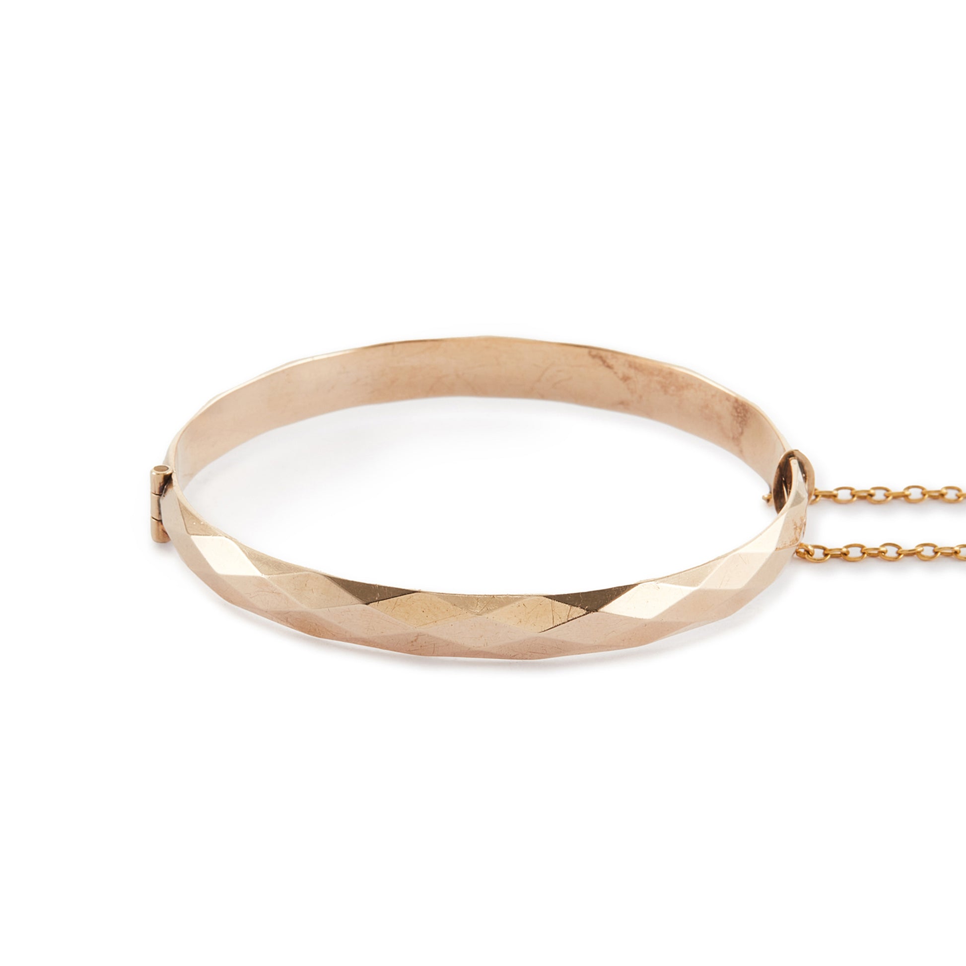 Classic 9ct rose gold (⅕) rolled gold bangle with harlequin design. Safety chain attached.