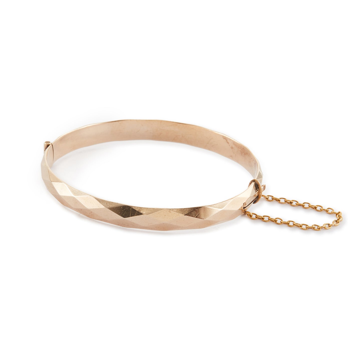 Classic 9ct rose gold (⅕) rolled gold bangle with harlequin design. Safety chain attached.