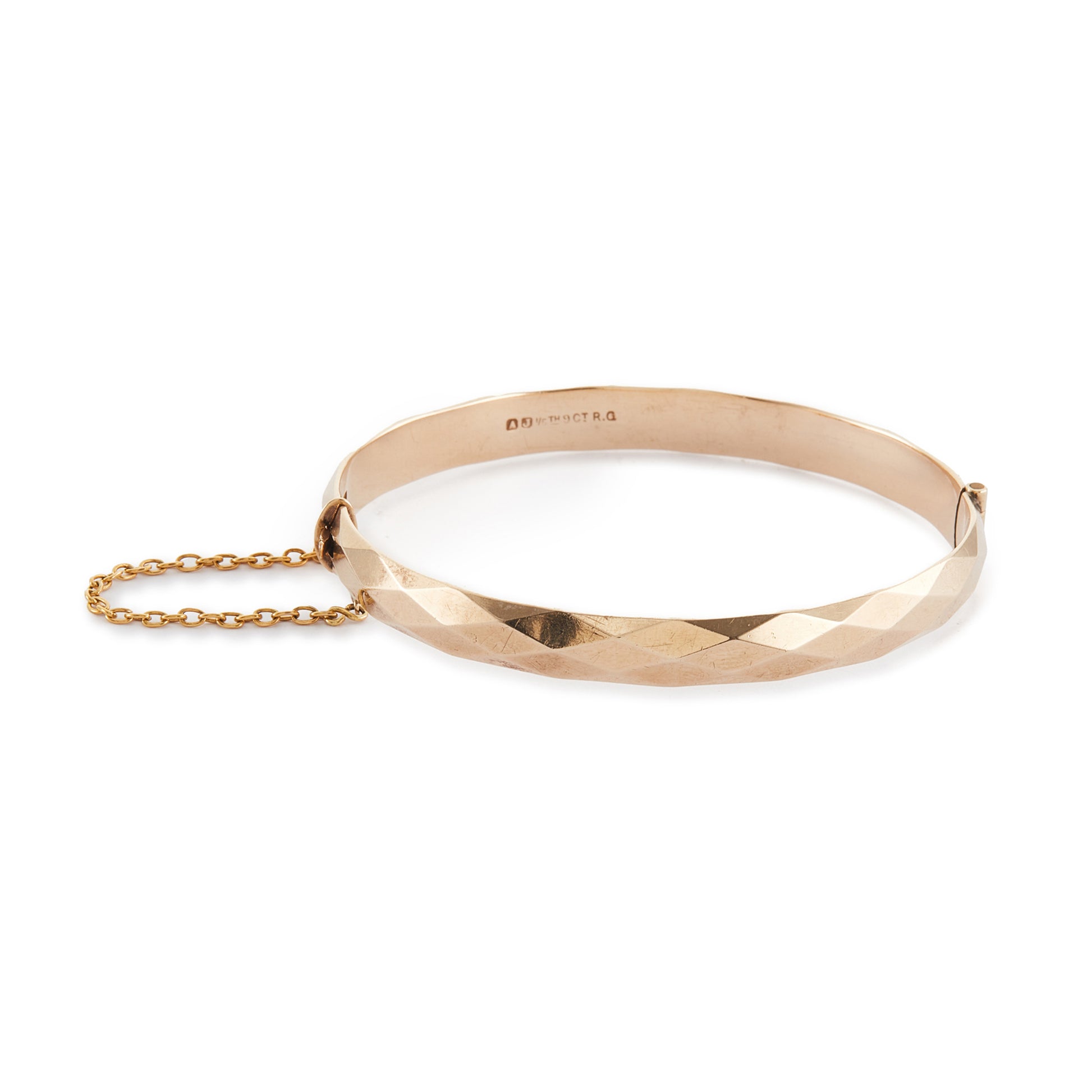 Classic 9ct rose gold (⅕) rolled gold bangle with harlequin design. Safety chain attached.