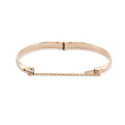 Classic 9ct rose gold (⅕) rolled gold bangle with harlequin design. Safety chain attached.