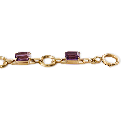 Classic 9ct rose gold bracelet set with six faceted rectangular deep purple amethysts and a bolt ring clasp.&nbsp;