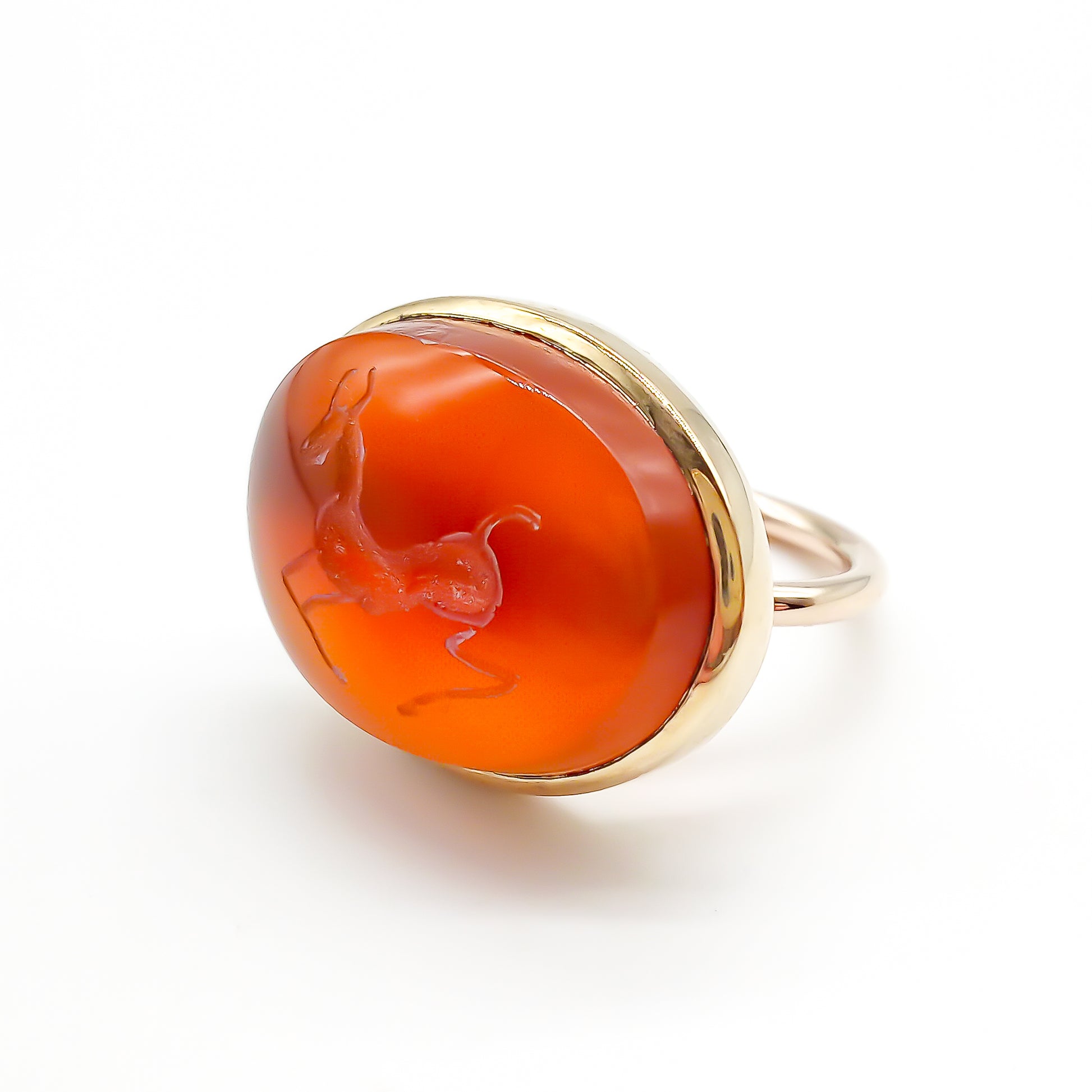 Unusual 9ct rose gold ring set with an antique oval carnelian intaglio depicting a stag.