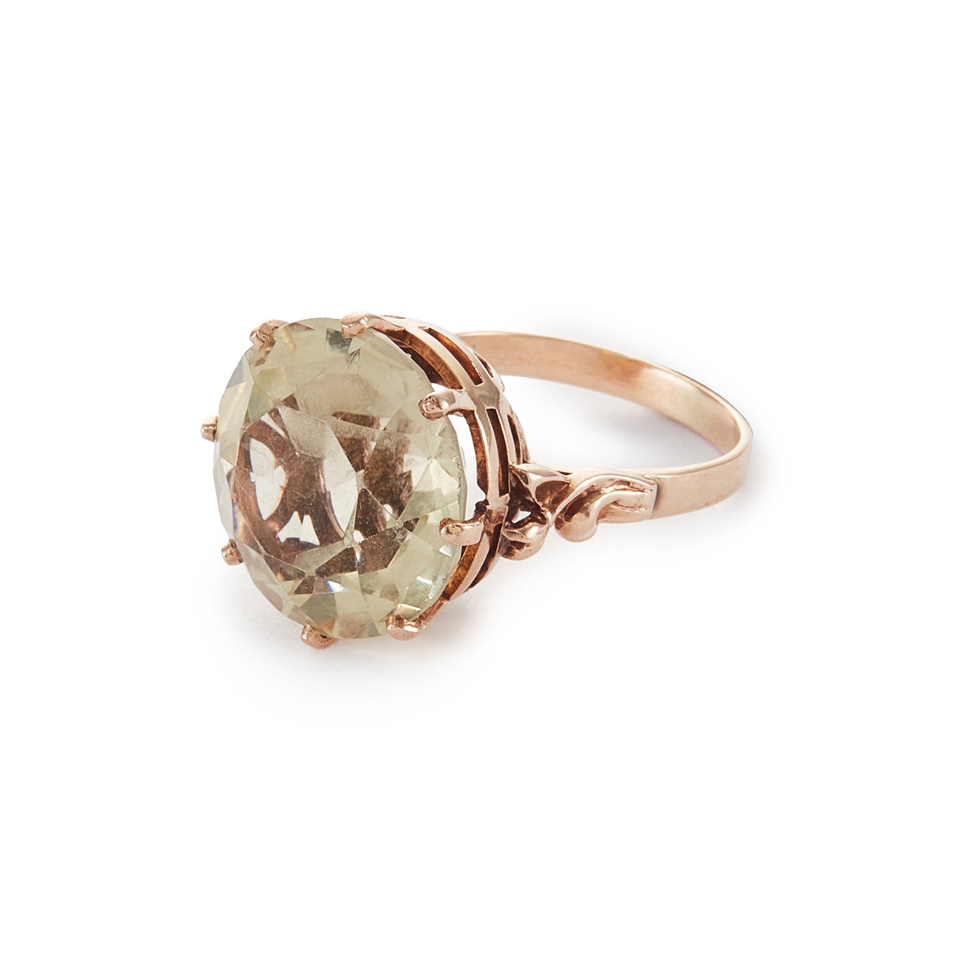 Stylish 9ct gold ring set with a light coloured citrine in an elevated claw setting. Ornate flower detail on the shoulders.