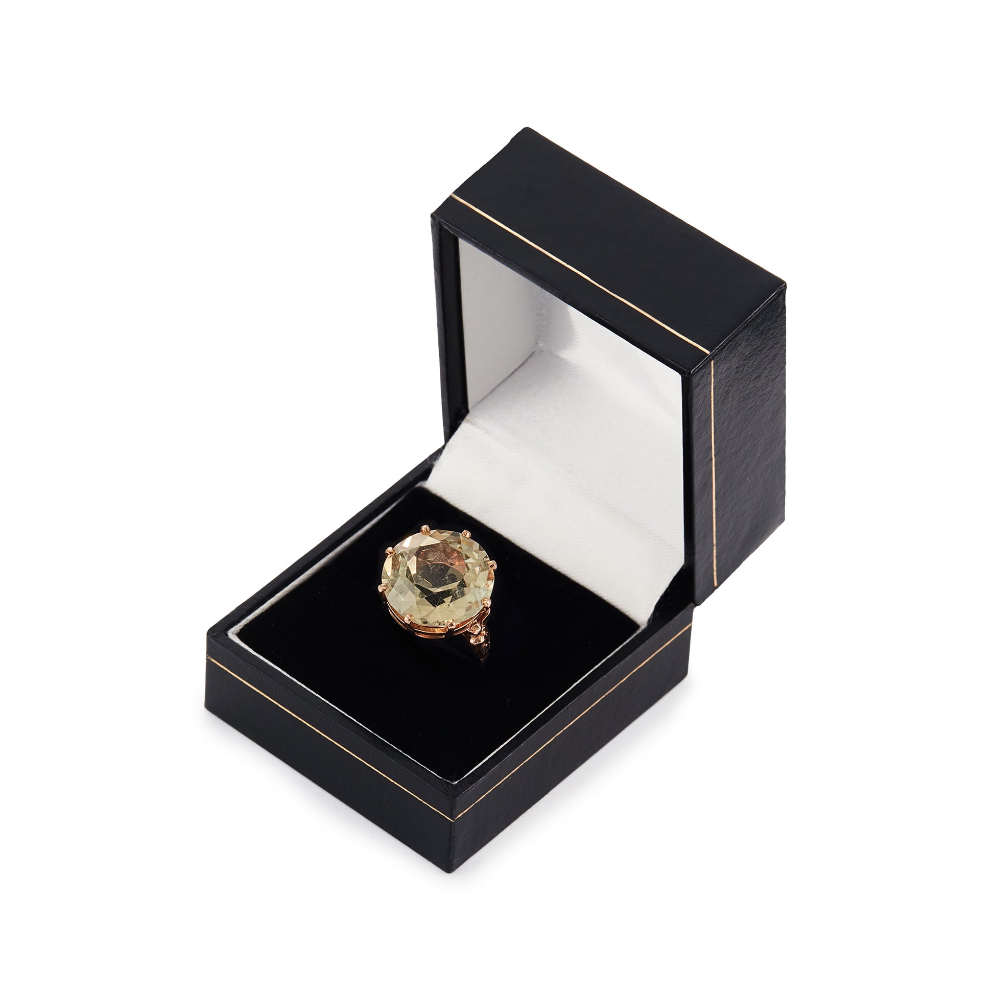 Stylish 9ct gold ring set with a light coloured citrine in an elevated claw setting. Ornate flower detail on the shoulders.