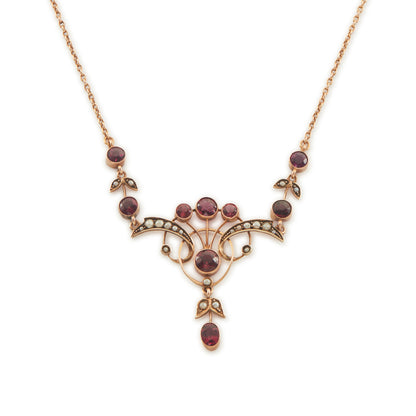Exquisite Edwardian 9ct rose gold necklace set with nine rhodolite garnets and eighteen seed pearls.