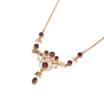 Exquisite Edwardian 9ct rose gold necklace set with nine rhodolite garnets and eighteen seed pearls.