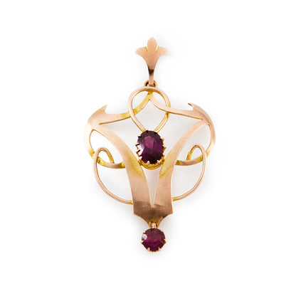 Pretty 9ct rose gold Art Nouveau pendant set with two faceted purple-red garnets.