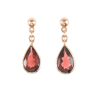 Vintage 9ct rose gold earrings, each set with a beautifully faceted teardrop-shaped garnet with a deep red hue.