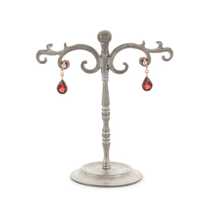 Vintage 9ct rose gold earrings, each set with a beautifully faceted teardrop-shaped garnet with a deep red hue.