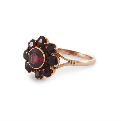Lovely 9ct rose gold ring set with nine beautifully faceted Bohemian garnets in the shape of a flower.