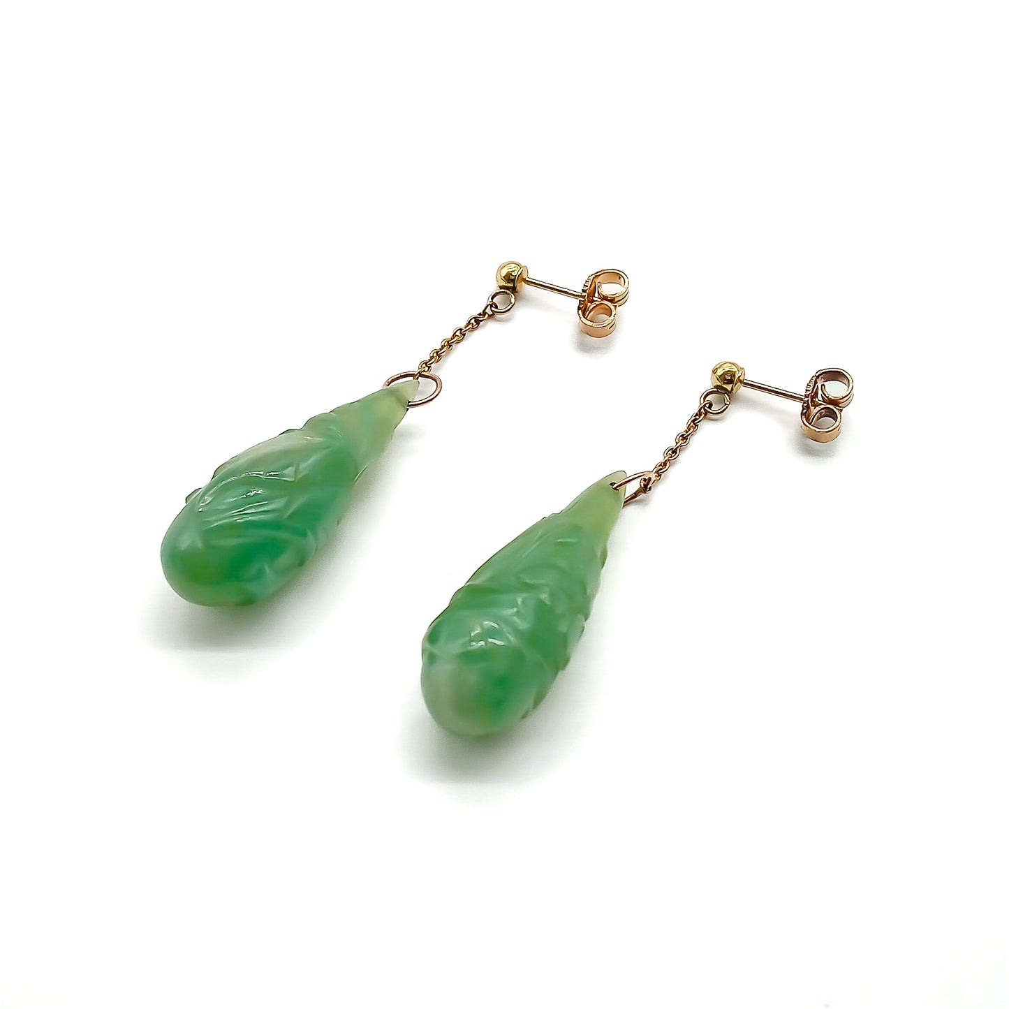 Sought-after 9ct rose gold dangling earrings, each set with a beautifully carved pear-shaped jade drop. Circa 1940’s