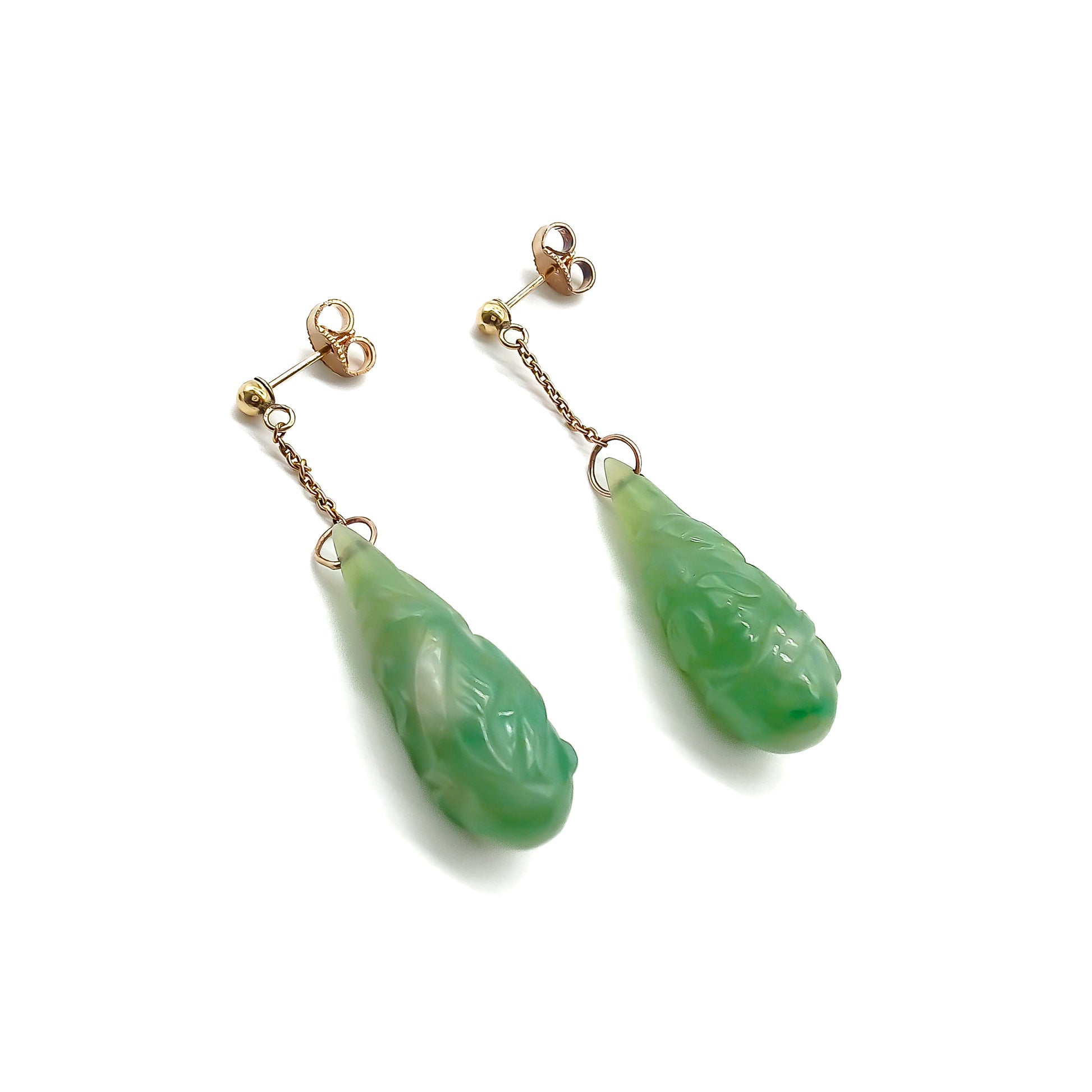 Sought-after 9ct rose gold dangling earrings, each set with a beautifully carved pear-shaped jade drop. Circa 1940’s