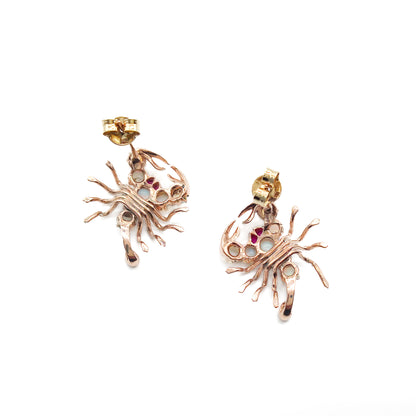 Charming 9ct rose gold earrings, each set with seven cabochon opals, ruby eyes and a ruby tail. Circa 1930’s