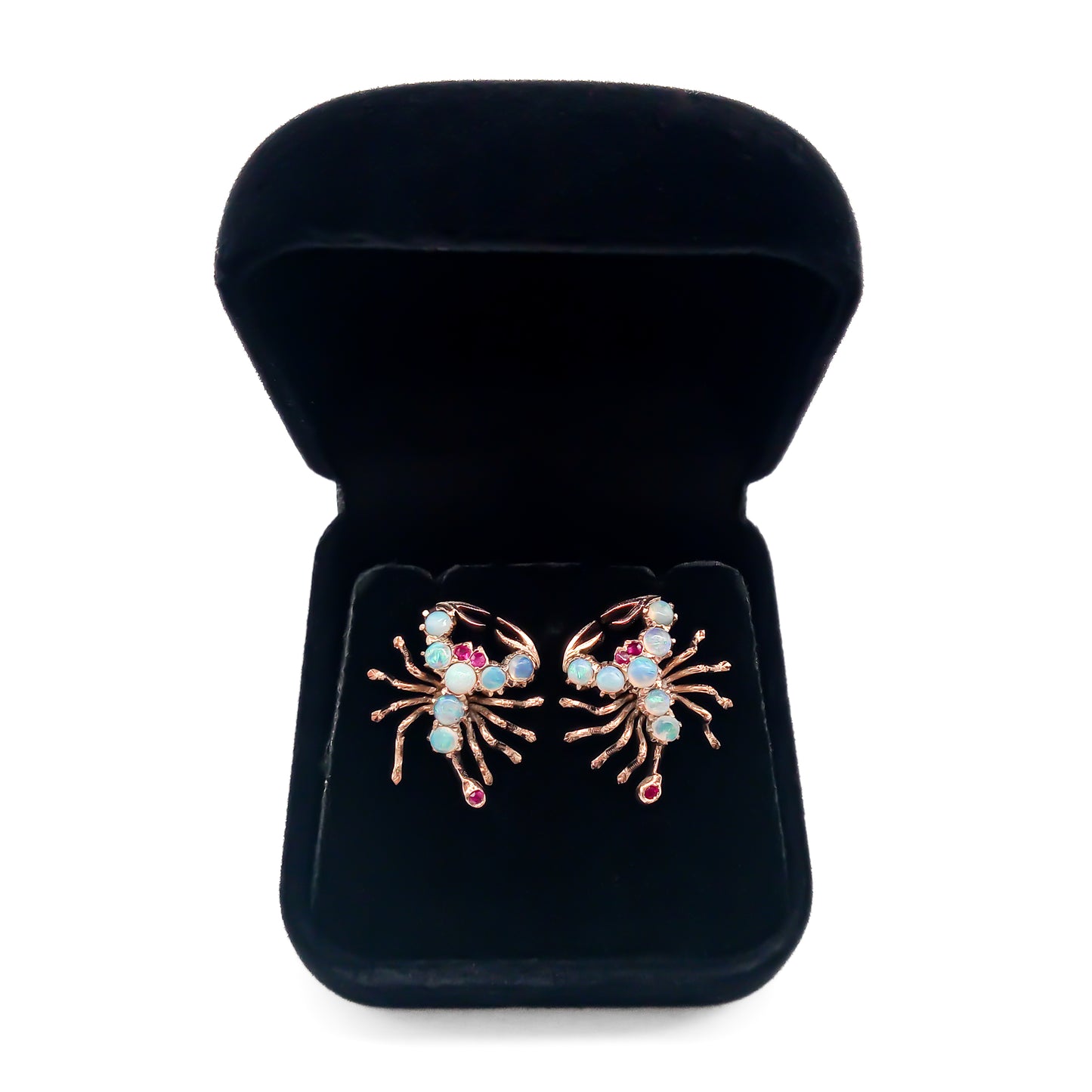 Charming 9ct rose gold earrings, each set with seven cabochon opals, ruby eyes and a ruby tail. Circa 1930’s