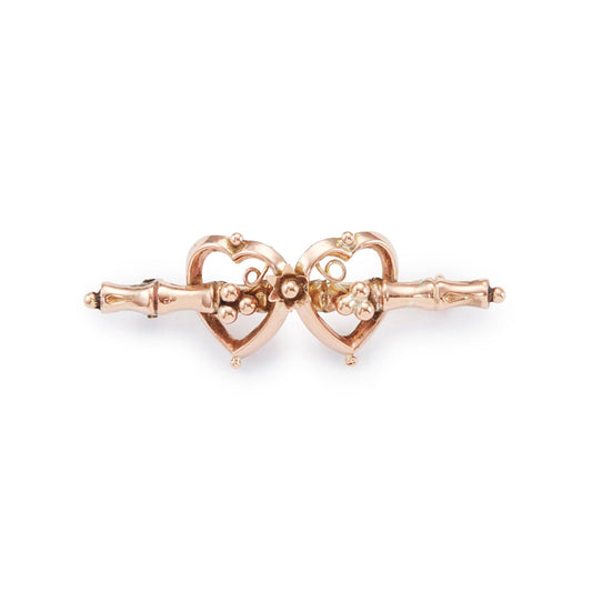 Pretty Victorian 9ct rose gold brooch depicting two hearts with floral details.