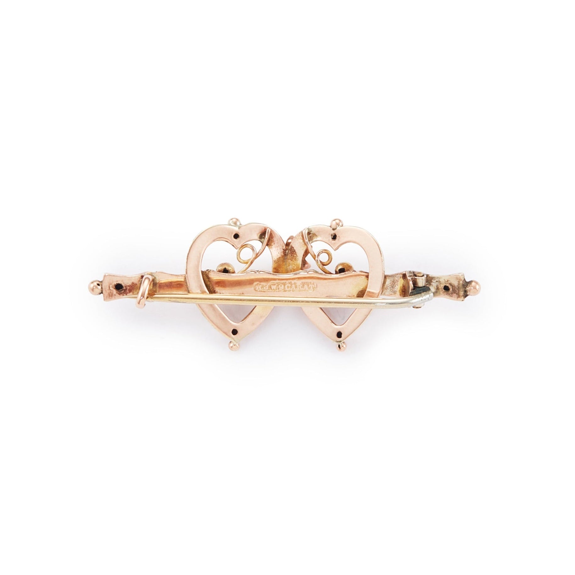 Pretty Victorian 9ct rose gold brooch depicting two hearts with floral details.