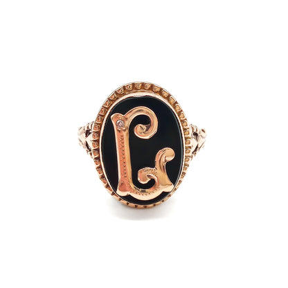 Classic 9ct rose gold and onyx signet ring with a fancy script letter “L”, containing a small diamond.