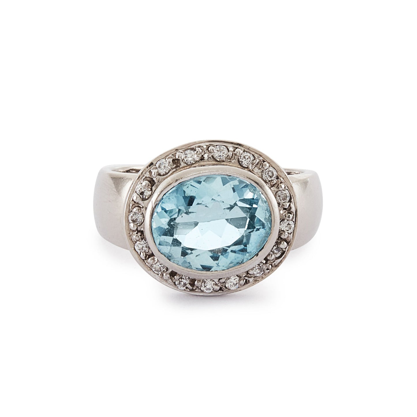 Stunning 9ct white gold ring set with a beautifully faceted blue topaz, surrounded by sixteen small round diamonds.