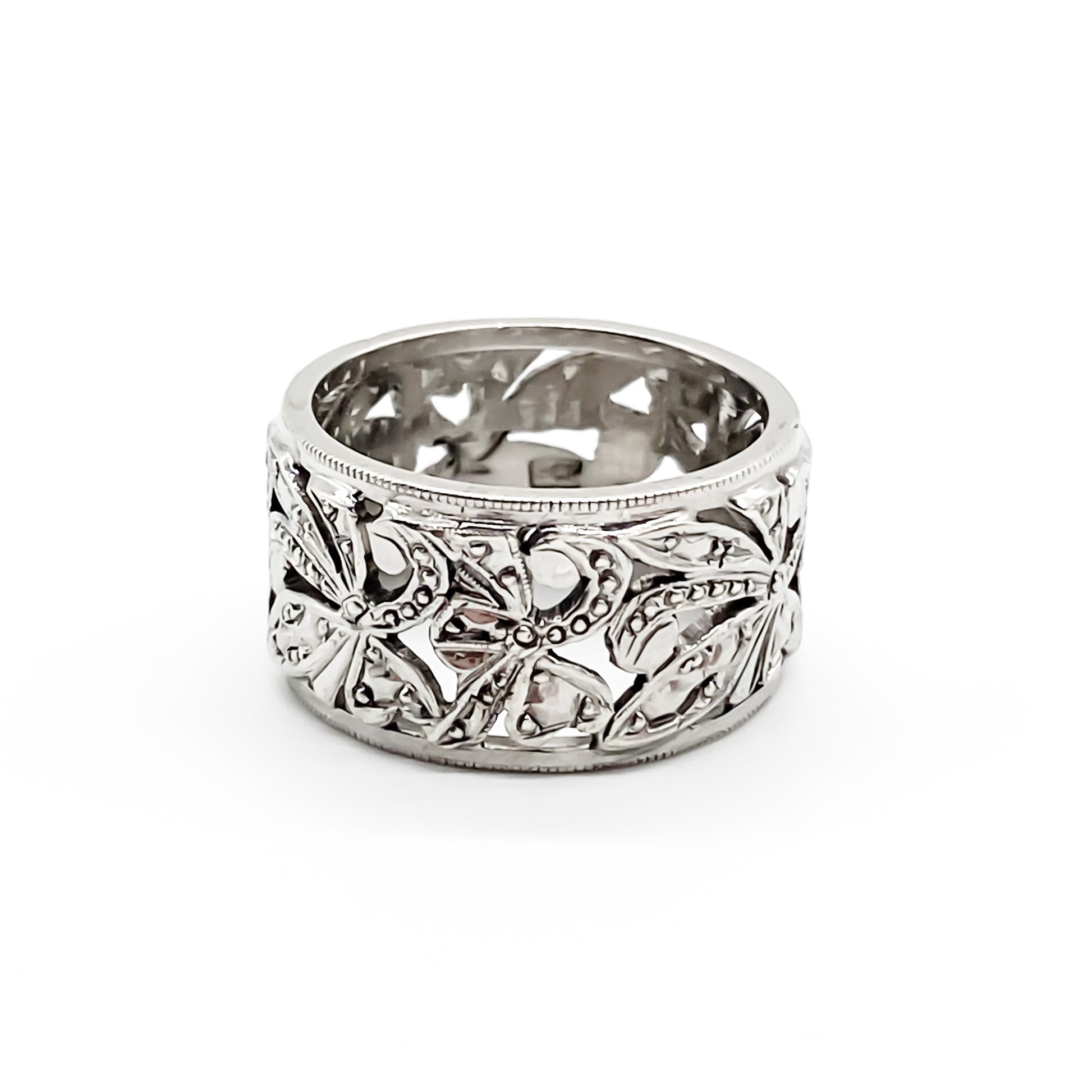 Ornate 9ct white gold band with intricate leaf design.