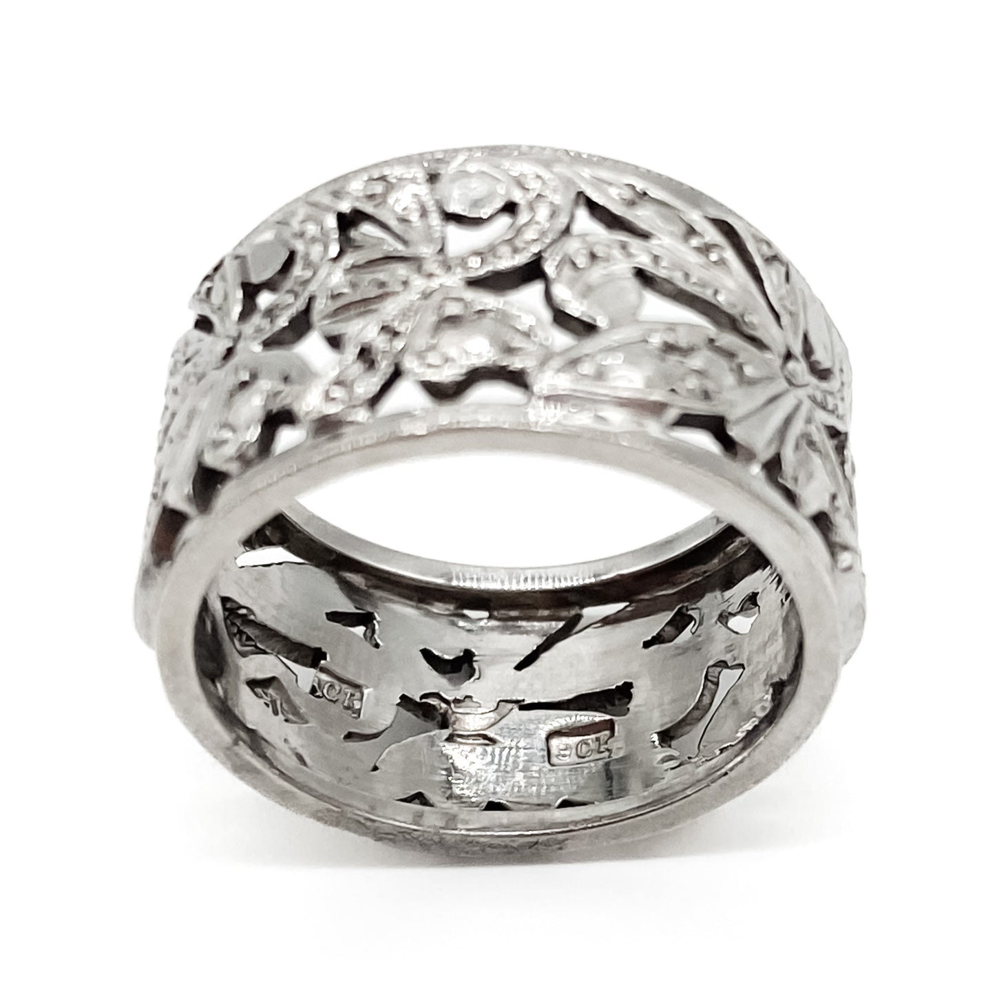 Ornate 9ct white gold band with intricate leaf design.