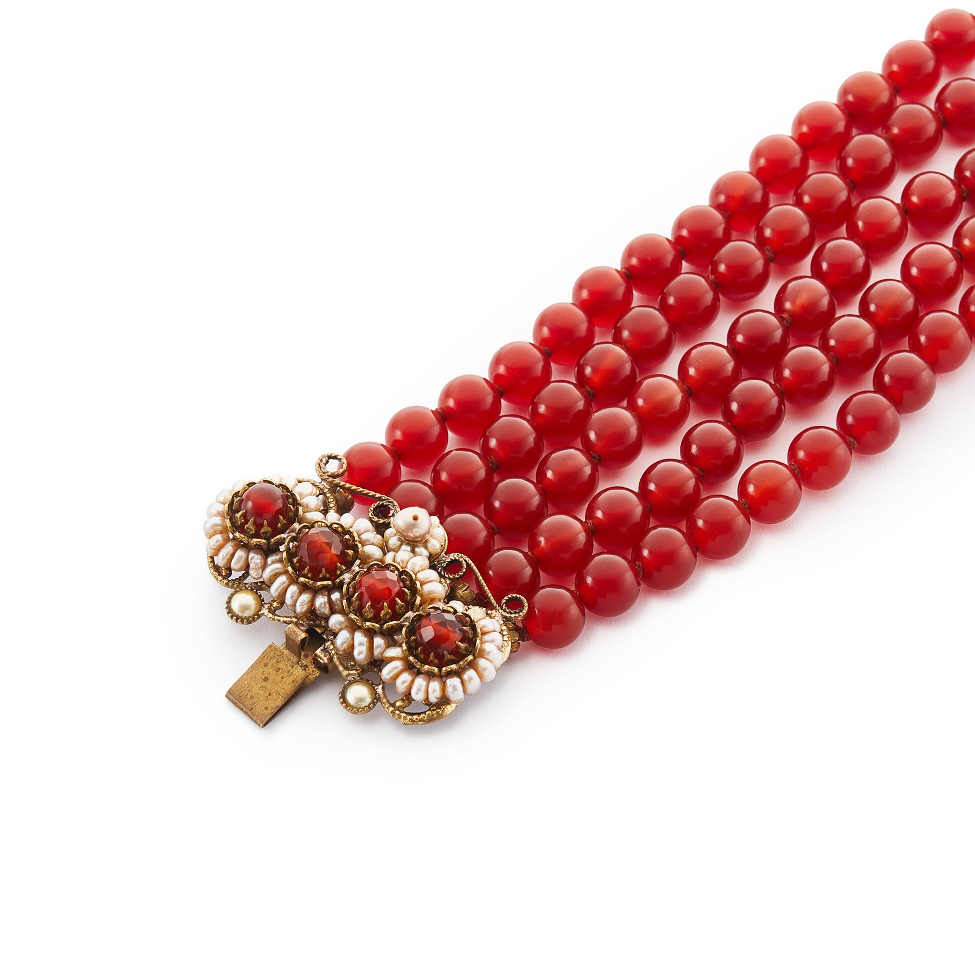 Spectacular antique carnelian five-strand bracelet with a very ornate brass, carnelian and seed pearl clasp. A real statement piece!
