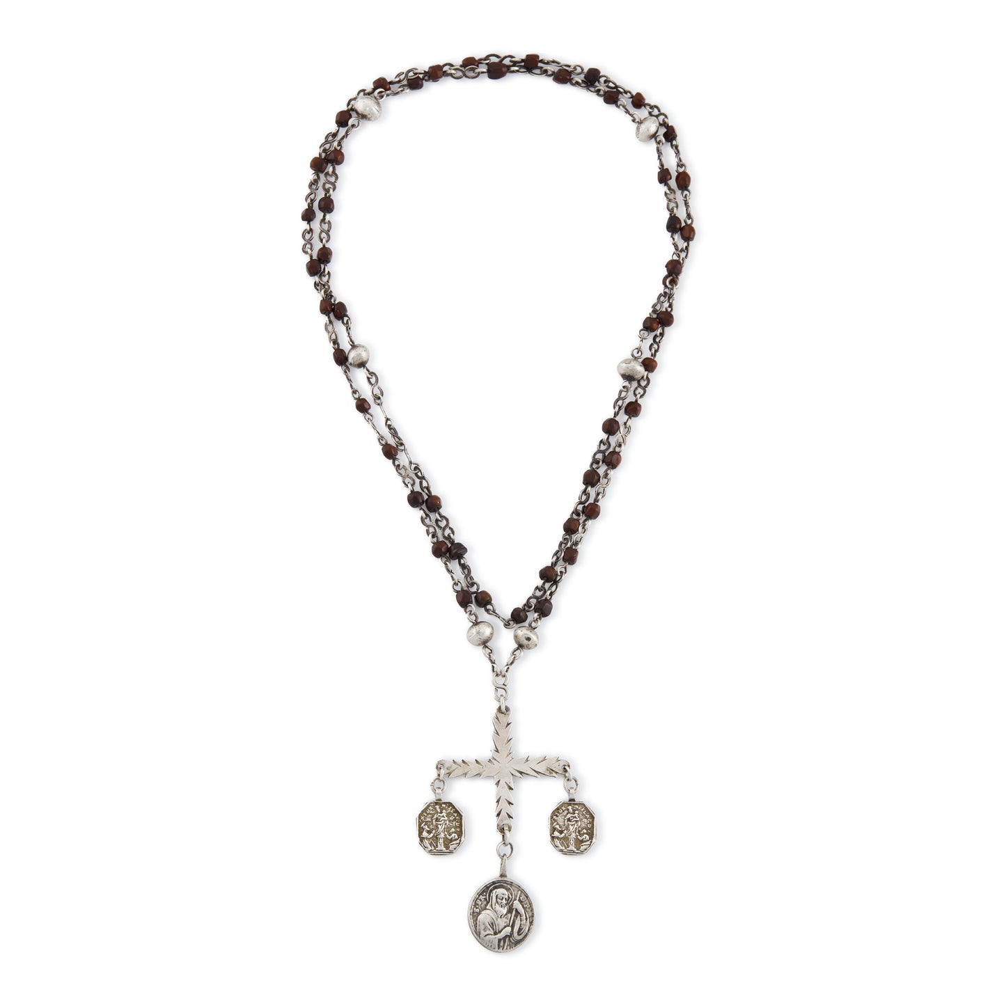 Stunning antique silver rosary with a cross and three dangling saint discs. The cross hangs on a 102cm oxidised silver ornate link chain, interspersed with natural red-brown stones and six silver bobbles.