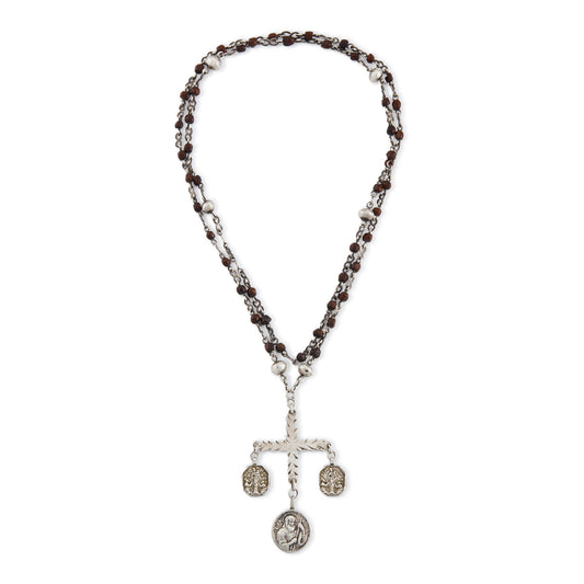 Stunning antique silver rosary with a cross and three dangling saint discs. The cross hangs on a 102cm oxidised silver ornate link chain, interspersed with natural red-brown stones and six silver bobbles.