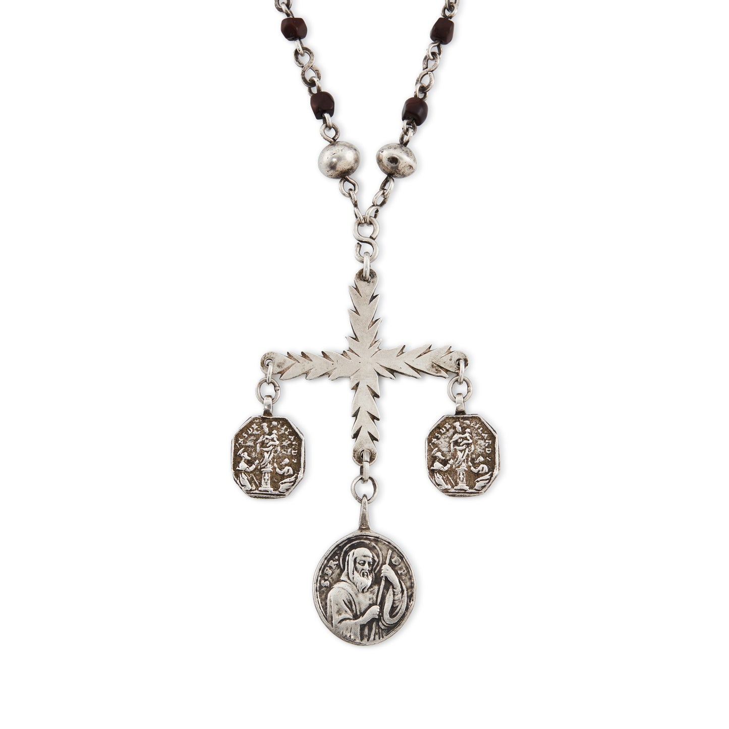 Stunning antique silver rosary with a cross and three dangling saint discs. The cross hangs on a 102cm oxidised silver ornate link chain, interspersed with natural red-brown stones and six silver bobbles.
