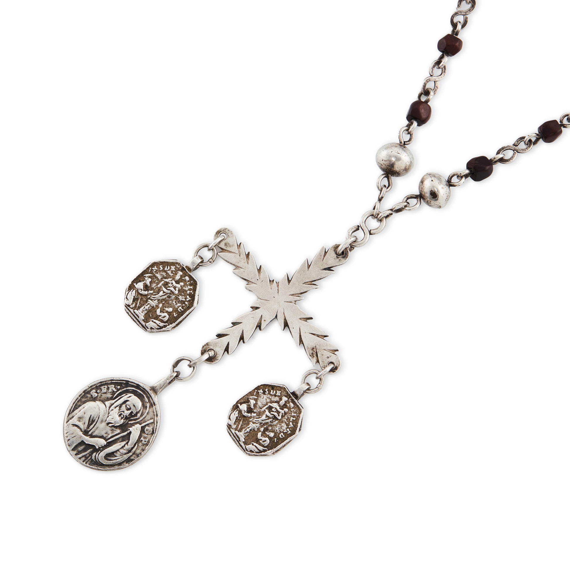 Stunning antique silver rosary with a cross and three dangling saint discs. The cross hangs on a 102cm oxidised silver ornate link chain, interspersed with natural red-brown stones and six silver bobbles.