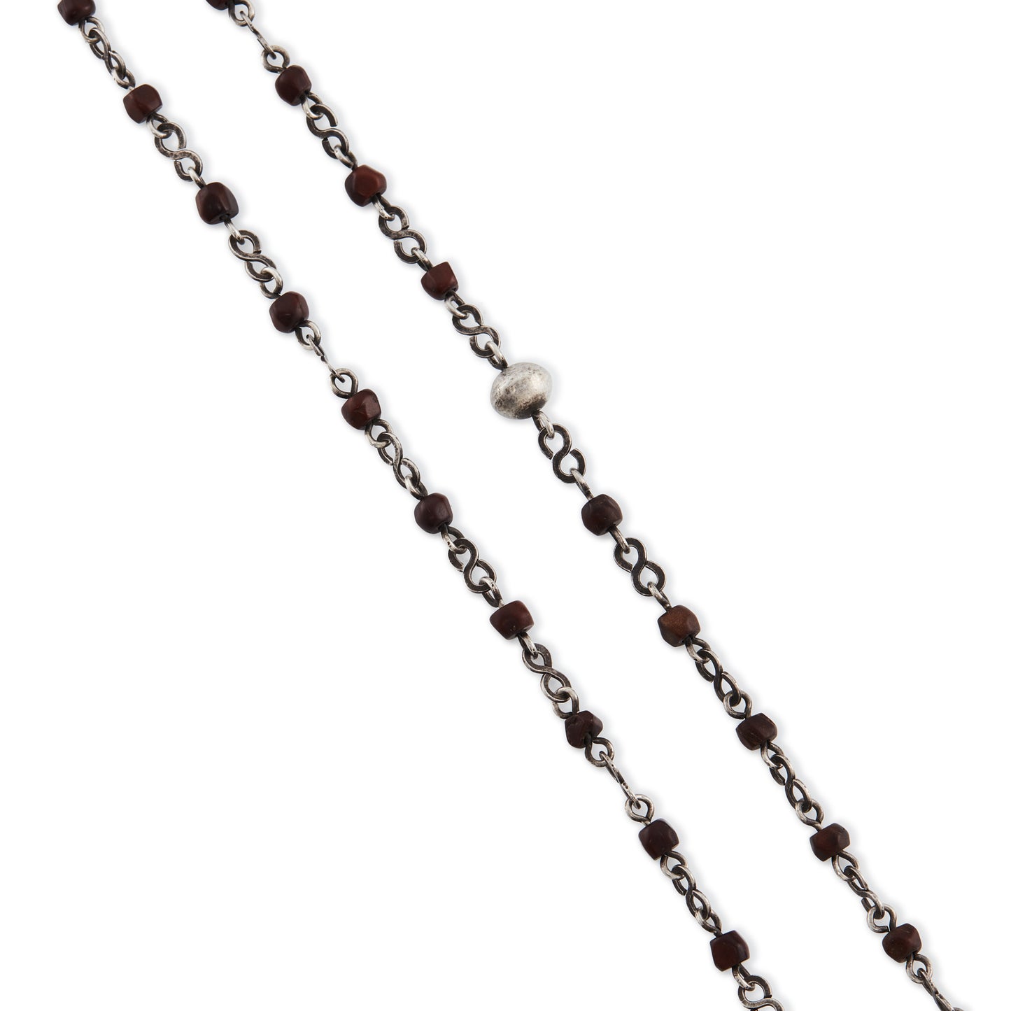 Stunning antique silver rosary with a cross and three dangling saint discs. The cross hangs on a 102cm oxidised silver ornate link chain, interspersed with natural red-brown stones and six silver bobbles.