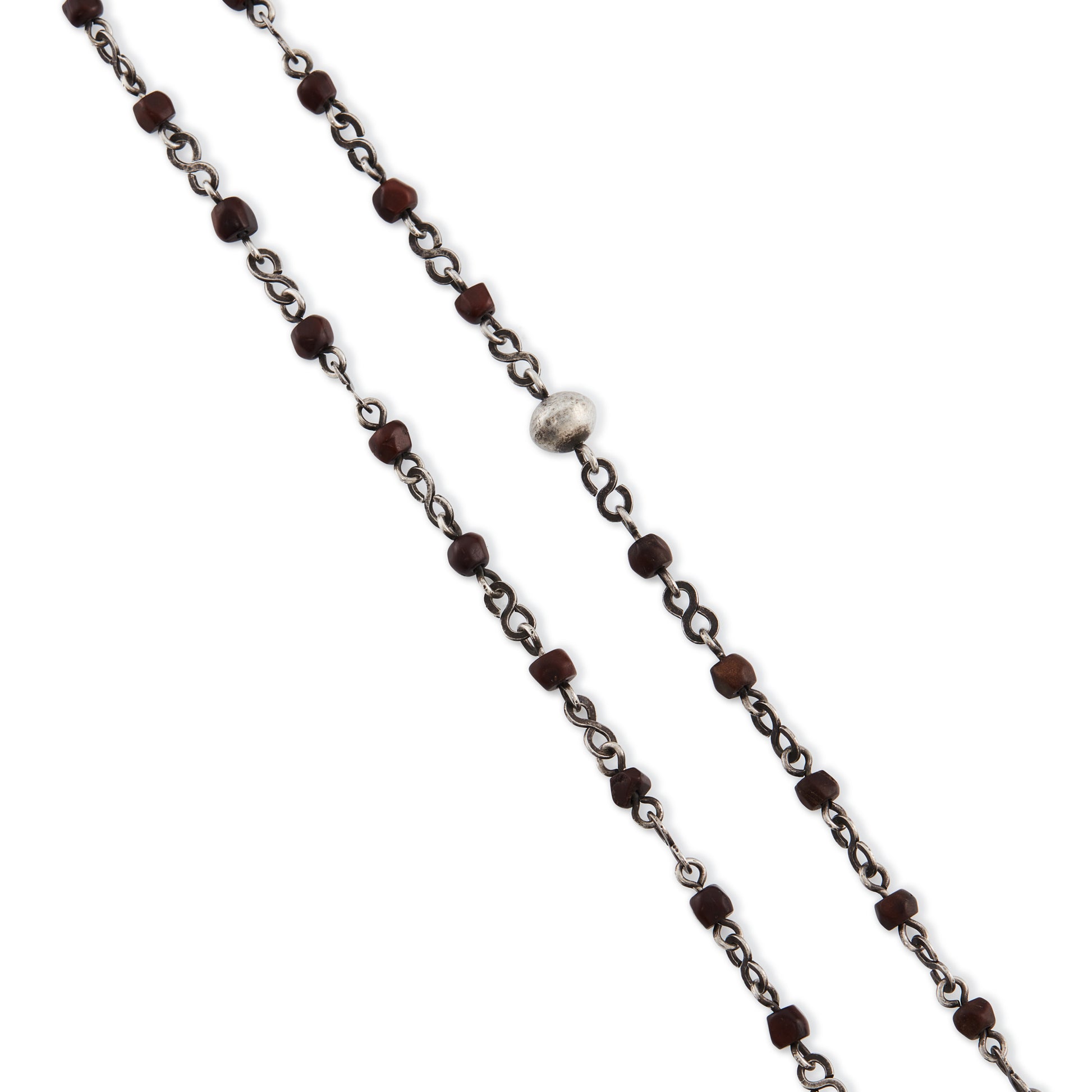 Stunning antique silver rosary with a cross and three dangling saint discs. The cross hangs on a 102cm oxidised silver ornate link chain, interspersed with natural red-brown stones and six silver bobbles.